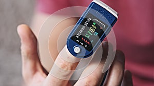 Pulse Oximeter Measures Pulse and Oxygen Saturation on a Male Finger Close-Up