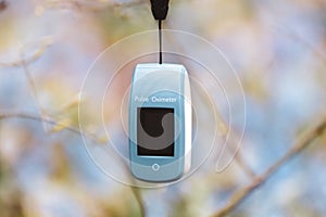 Pulse oximeter outdoors close-up in spring nature