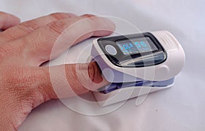 Pulse oximeter on the patient's hand