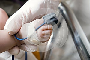Pulse oximeter sensor on a baby