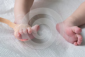 Pulse oximeter sensor on the feet of newborn baby in a hospital bed close-up