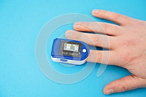 Pulse oximeter used to measure pulse rate and oxygen levels with hand