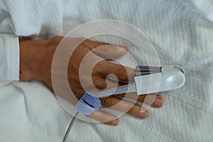 Pulse oximetry on patient hand in the ward at hospital photo