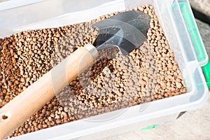 Pumice pebbles in bucket and gardening tool