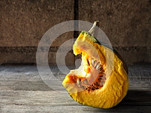 Pumkin yellow and half of ball on wood background