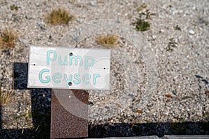 Pump Geyser sign, a hot spring thermal feature in the Upper Geyser Basin in Yellowstone National Park