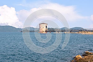 A pump house in the middle of the maithon lake with beautiful clouds