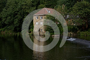 Pump house beside a quite river bank