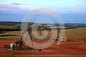 Pump Jack with Fields and Flares in Background