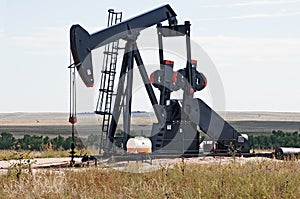 Pump jack lifting crude oil