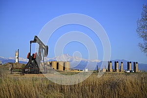 Pump Jack Oil Well with Longs Peak and tank farm