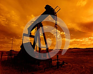 A pump jack at sunset in a Wyoming oil field