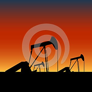 Pump jacks on oil wells at sunset