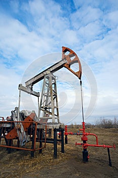 Pump-rocking chair at an oil field in the spring.
