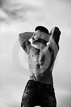 Pumped man. man with muscular body on blue sky