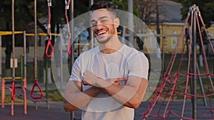 Pumped sportive millennial Middle Eastern Arab guy shows big biceps, proud of athletic achievements. Young Indian