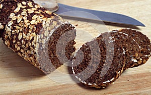 Pumpernickel bread slices and knife photo