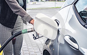 Pumping gas and diesel at pump. Close-up of a fuel pistol for refueling gasoline and diesel.