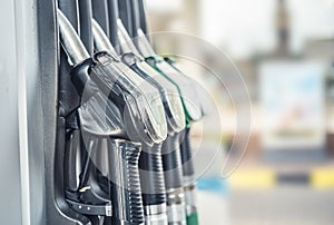 Pumping gas and diesel at pump. Close-up of a fuel pistol for refueling gasoline and diesel.