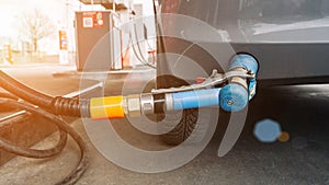 Pumping gas fuel car at oil station. Woman hand refuel petrol nozzle tank. Refueling transportation and Automotive