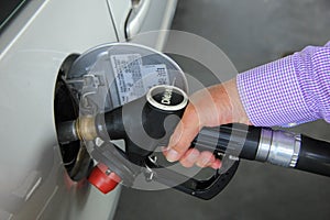 Pumping gas at a gas station