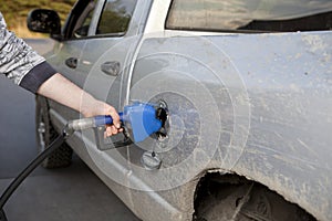 Pumping gas into a pickup truck