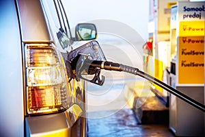 Pumping gasoline fuel in a car at a gas station. transport concept.