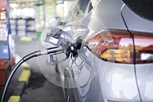 Pumping petrol diesel fuel in car at gas station