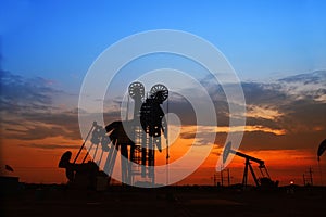 Pumping unit and the silhouette of oilfield derrick