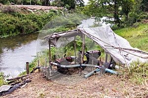 Pumping water from the well was put in by the pump-old farmer