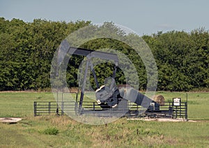 Pumpjack with a hay bale in the State of Oklahoma in the United States of America.