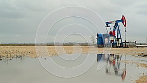 Pumpjack Oil Pump operating on natural gas in the field pumping from the oil well