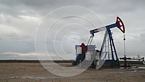 Pumpjack Oil Pump operating on natural gas in the field pumping from the oil well