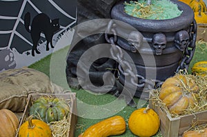 Pumpkin in a box with straw. vase with skulls