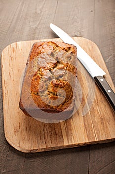 Pumpkin bread on cutting board slightly above shot