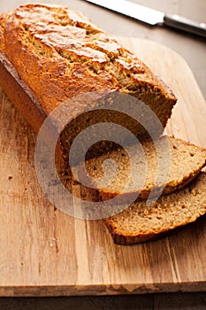 Pumpkin bread on cutting board vertical shot