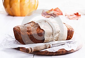 Pumpkin bread loaf over white wooden background