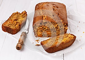 Pumpkin bread loaf over white wooden background