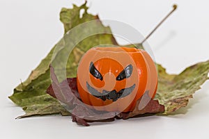 Pumpkin candle and rusty leafs