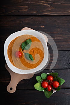 Pumpkin and carrot cream soup  in bowl on a wooden background. Rustic, food.