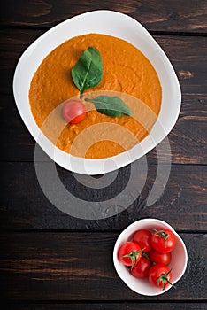 Pumpkin and carrot cream soup  in bowl on a wooden background. Rustic, food.