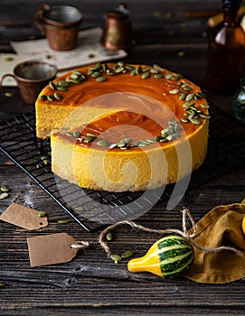 Pumpkin cheesecake with caramel sauce and seeds on top