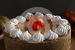 Pumpkin cheesecake with meringue on the cozy autumn background