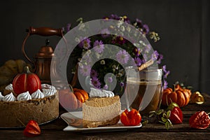 Pumpkin cheesecake with meringue on the cozy autumn background