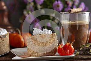 Pumpkin cheesecake with meringue on the cozy autumn background