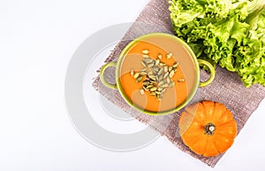 Pumpkin cream soup with croutons and seeds. Copy space