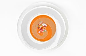 Pumpkin cream soup with cucumbers, tomatoes, shrimp and olive oil