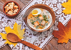 Pumpkin cream-soup decorated with maple leaves, boiled egg and c