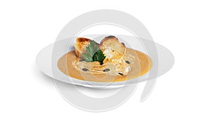 Pumpkin cream soup isolated on a white background.