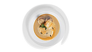 Pumpkin cream soup isolated on a white background.